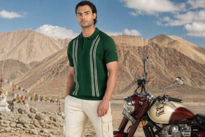 Royal Enfield Heritage Collection apparel green polo shirt man standing next to Royal Enfield motorcycle Ladakh