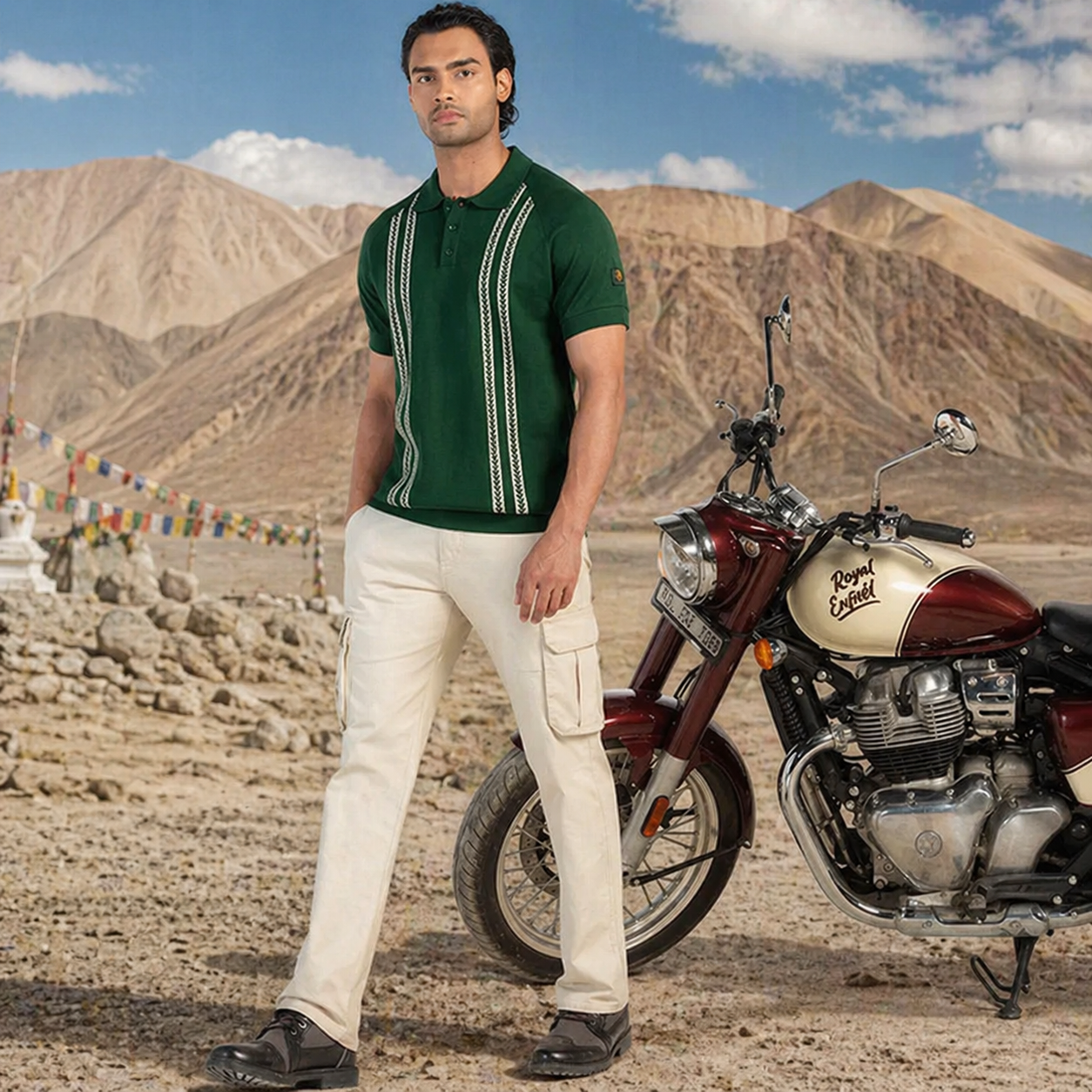 Royal Enfield Heritage Collection apparel green polo shirt man standing next to Royal Enfield motorcycle Ladakh