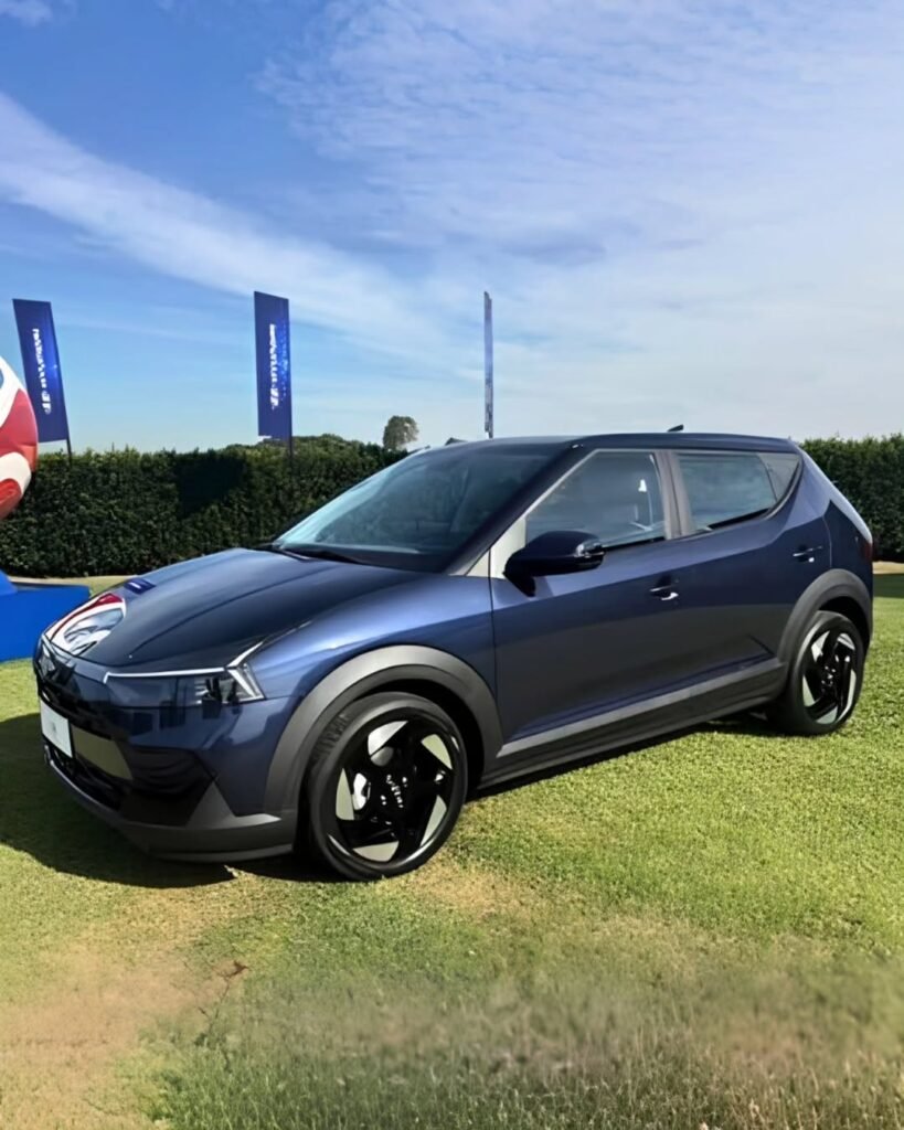 2027 Hyundai i20 blue side profile with black alloy wheels and plastic body cladding at FIFA world cup event
